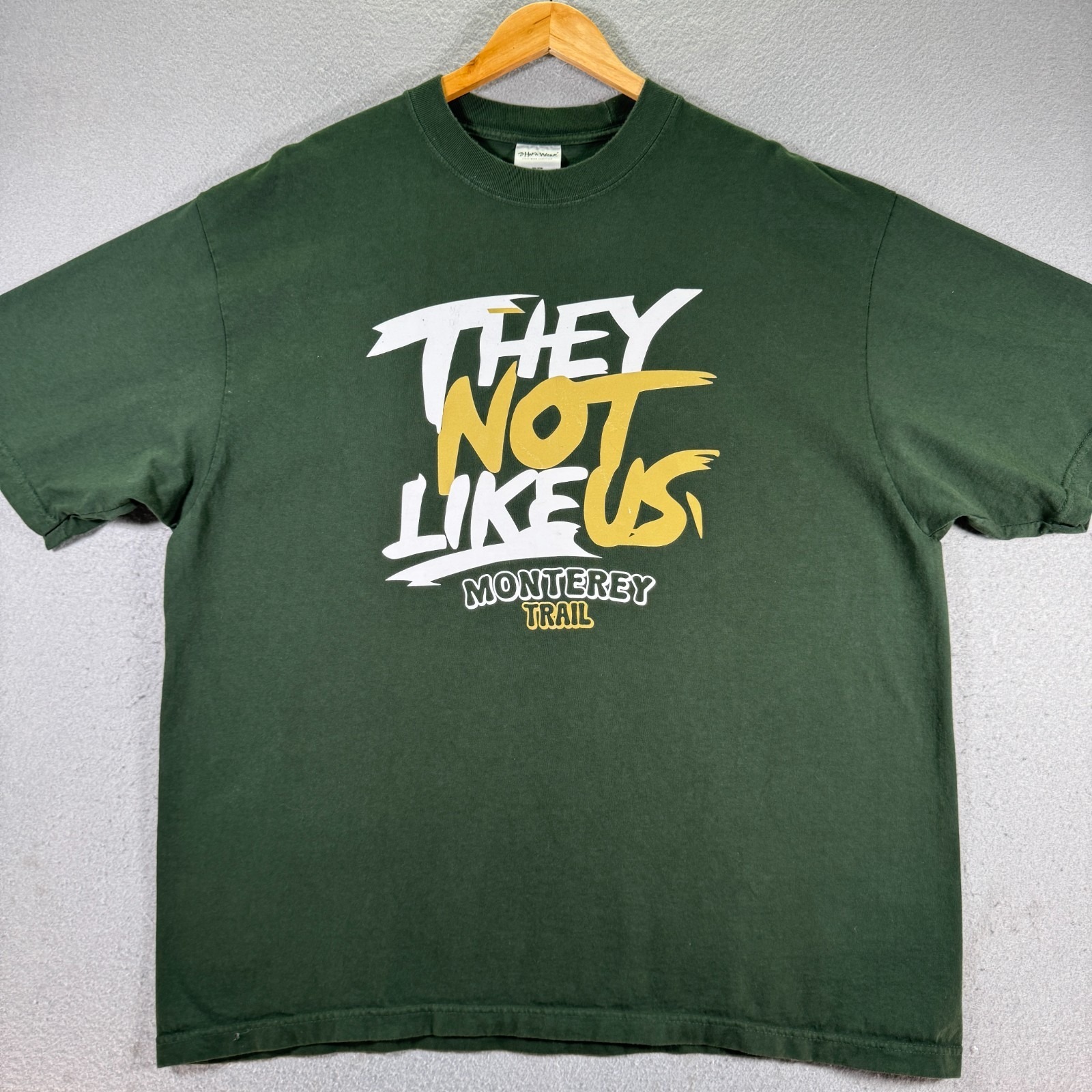 Monterey Trail They Not Like Us Adult Xl Green Graphic Shaka Wear Runners Tee